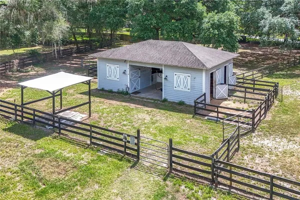 an aerial view of a house with a garden and lake view