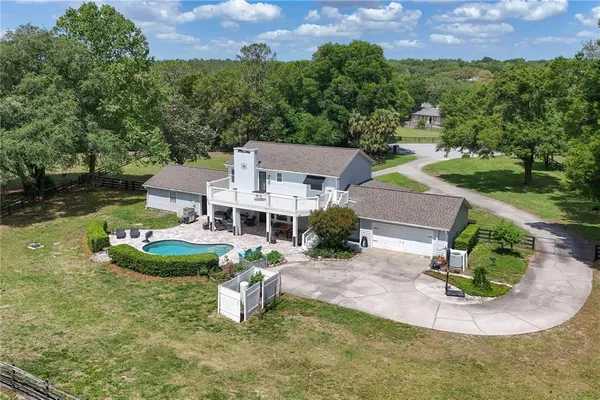 a view of a backyard with a patio and wooden fence