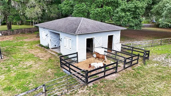 an aerial view of a house with a yard and lake view