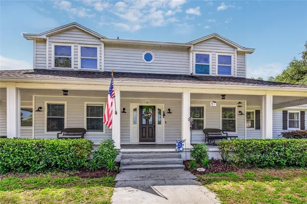 a aerial view of a house with swimming pool and yard