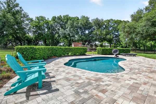 a view of a patio with table and chairs barbeque grill with wooden fence