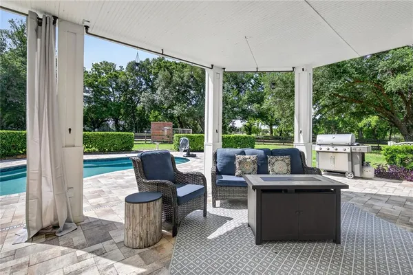 a view of a patio with a dining table and chairs