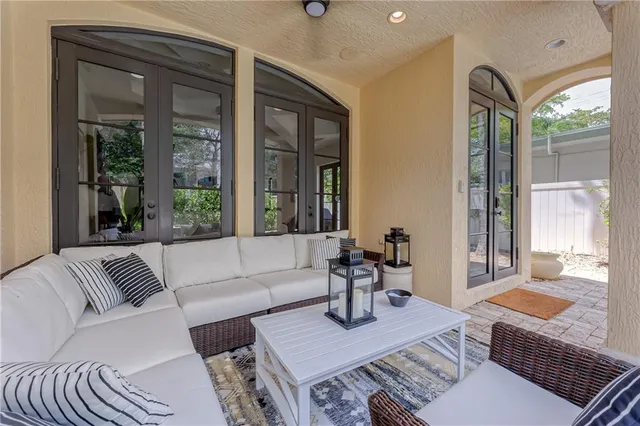 a living room with a couch and a potted plant