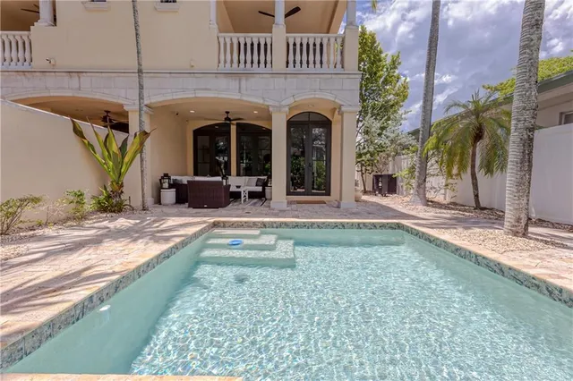 a roof deck with table and chairs