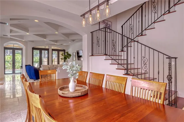 a living room with furniture a flat screen tv and a floor to ceiling window
