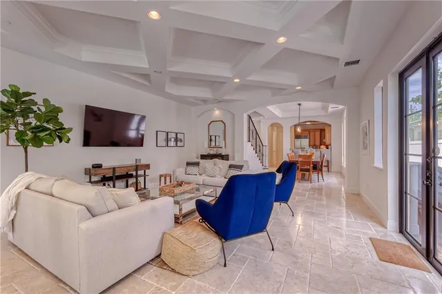 a view of a hallway with wooden floor and stairs