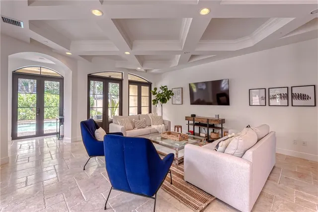 a bedroom with a large bed and a chandelier