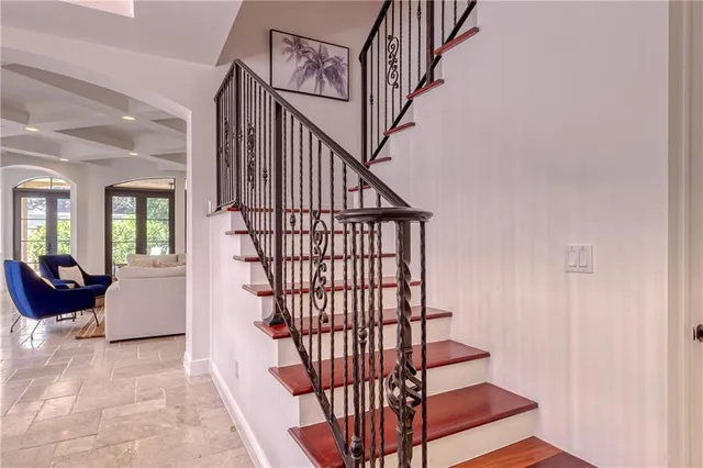a bedroom with a large bed and a chandelier