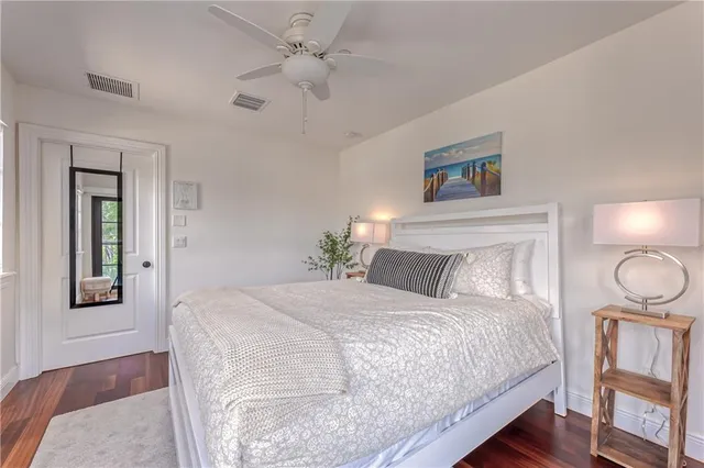 a bedroom with a large bed chandelier and a window