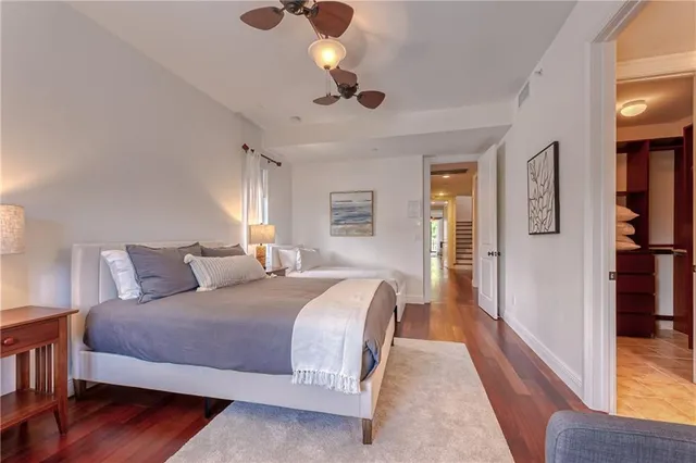 a bathroom with a granite countertop sink a toilet a mirror and shower