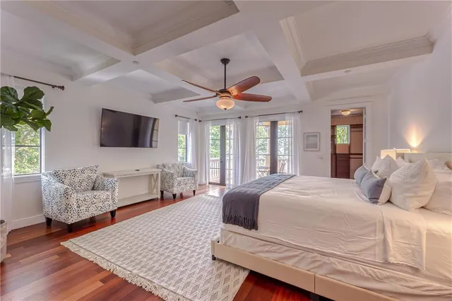 a bedroom with a large bed and a chandelier