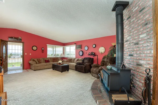 a living room with furniture a rug and a window