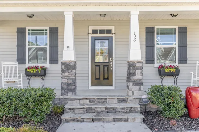 a front view of a house with a garden