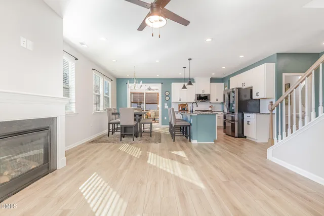 a view of a kitchen with dining table and chairs