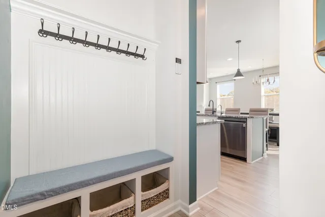 a kitchen with a refrigerator and white cabinets