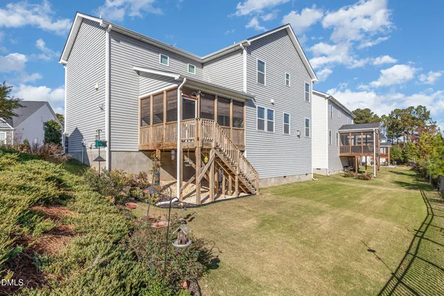 a view of a house with backyard and sitting area