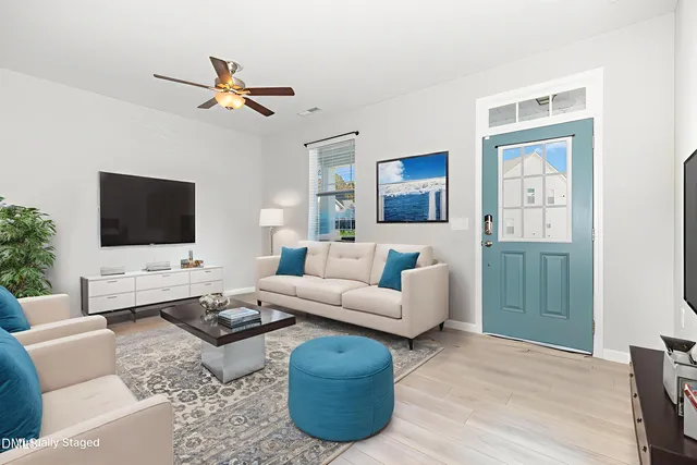 a living room with furniture and a flat screen tv