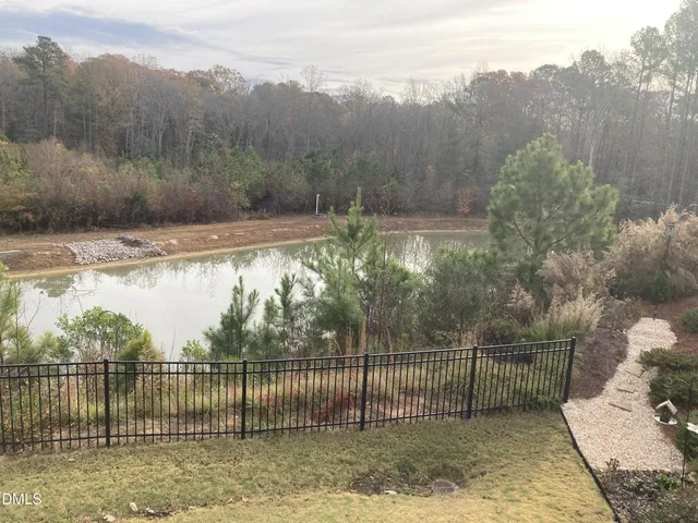 a view of a wrought iron fences next to a yard