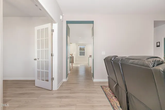 a view of a hallway with wooden floor and closet