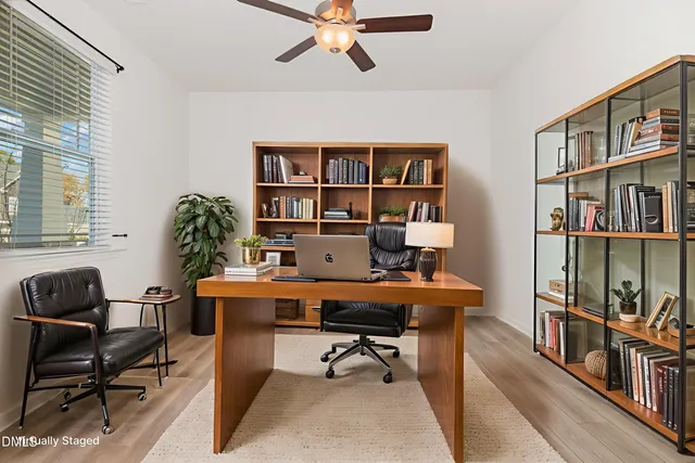 a view of a workspace with a bookshelf