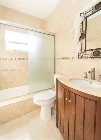 a bathroom with a toilet a sink and a shower