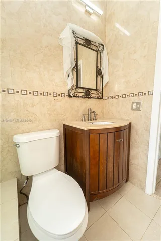 a bathroom with a toilet sink and vanity