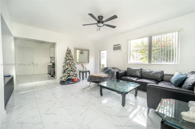 a living room with furniture and a large window