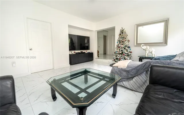 a living room with furniture and a flat screen tv