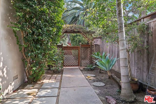a view of a pathway along the house