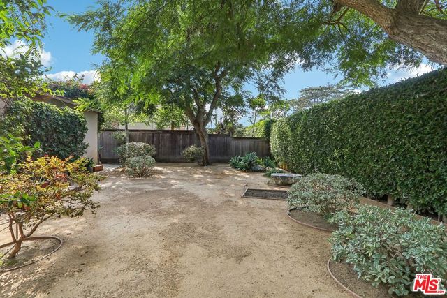a patio with wooden fence and roof