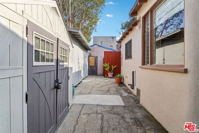 a backyard of a house with table and chairs
