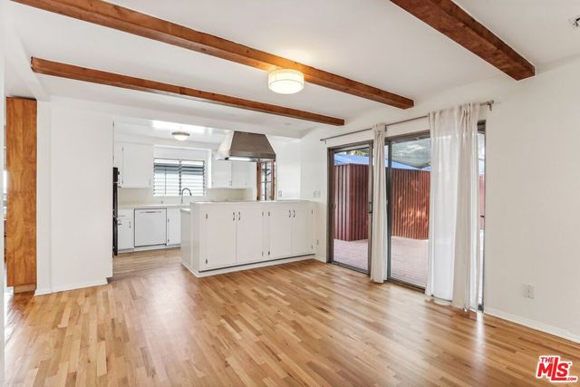 a view of a kitchen with wooden floor and a kitchen