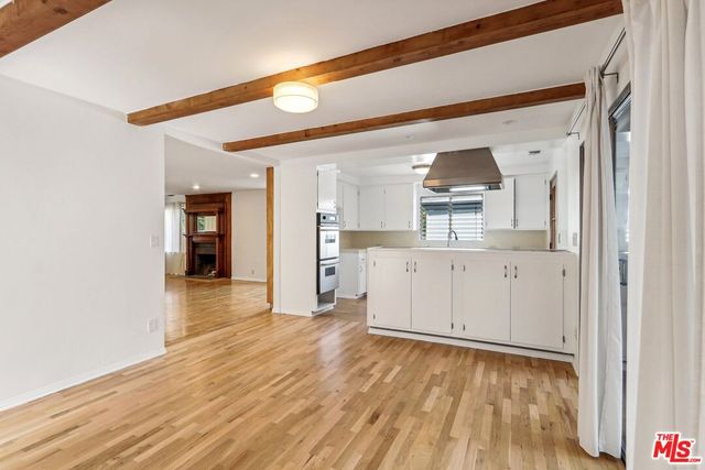 a view of a kitchen cabinets and wooden floor