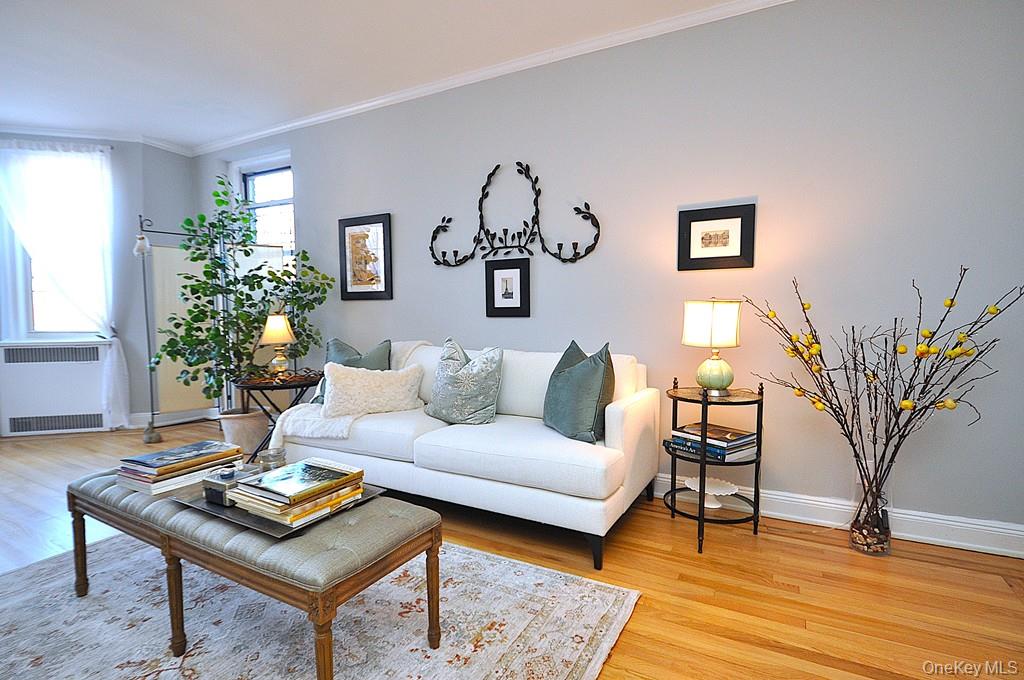 Oversized living room has a bay window, stunning hardwood floors and opens to the dining room.  The living room is approx 22'-3" x 12'-8"