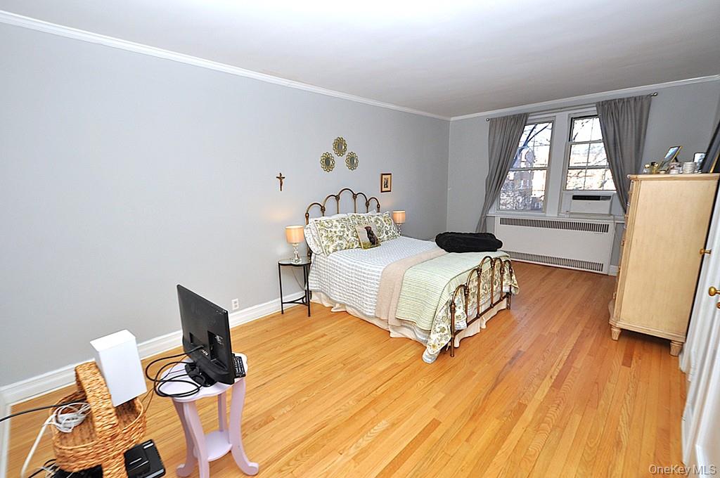 253 Garth Road, Unit 6J Scarsdale, NY 10583 - Photo 16 of 41 The oversized bedroom has stunning hardwood floors, can accommodate a king size bed, dresser, night stands and a comfy chair. The room is approx 202'-2" x 11'-3".