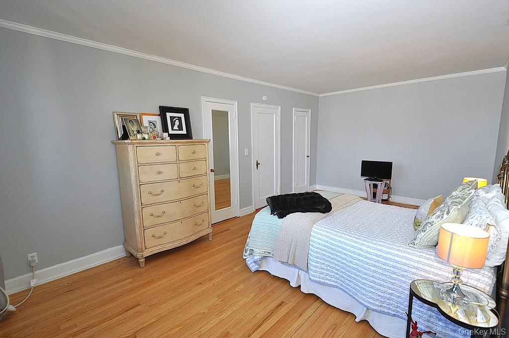 253 Garth Road, Unit 6J Scarsdale, NY 10583 - Photo 19 of 41 The oversized bedroom has stunning hardwood floors, can accommodate a king size bed, dresser, night stands and a comfy chair. The room is approx 202'-2" x 11'-3".