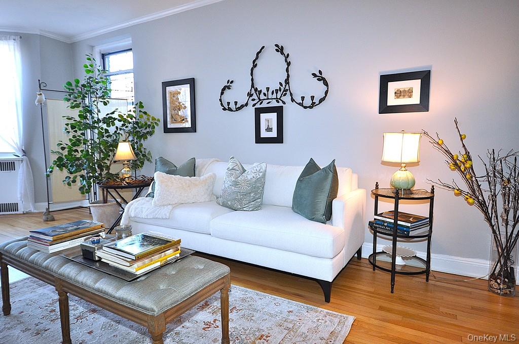 253 Garth Road, Unit 6J Scarsdale, NY 10583 - Photo 26 of 41 Oversized living room has a bay window, stunning hardwood floors and opens to the dining room. The living room is approx 22'-3" x 12'-8"