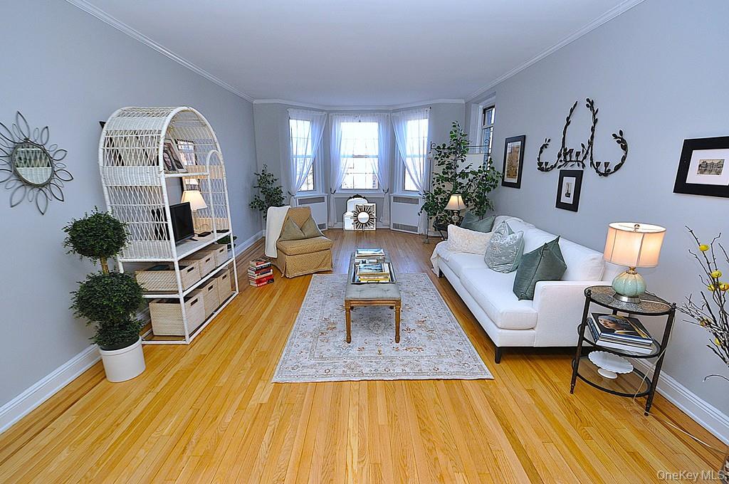 253 Garth Road, Unit 6J Scarsdale, NY 10583 - Photo 3 of 41 Oversized living room has a bay window, stunning hardwood floors and opens to the dining room. The living room is approx 22'-3" x 12'-8"