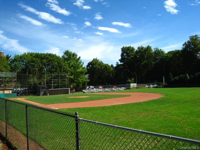 253 Garth Road, Unit 6J Scarsdale, NY 10583 - Photo 38 of 41 Garth Road Ball Field - Garth Road is a self contained tree lined street and 1/2 mile long starting at the Scarsdale Metro North Train Station and ending at the ball field. Easy walk to Scarsdale village and train. It's only a 33 minute train ride to Grand Central Terminal. As a resident you are entitled to join the Town’s Lake Isle Park, that features a Par 70, 18 hole golf course, 8 Tennis courts and 5 swimming pools including a 50 meter Olympic Pool with eight racing lanes.
