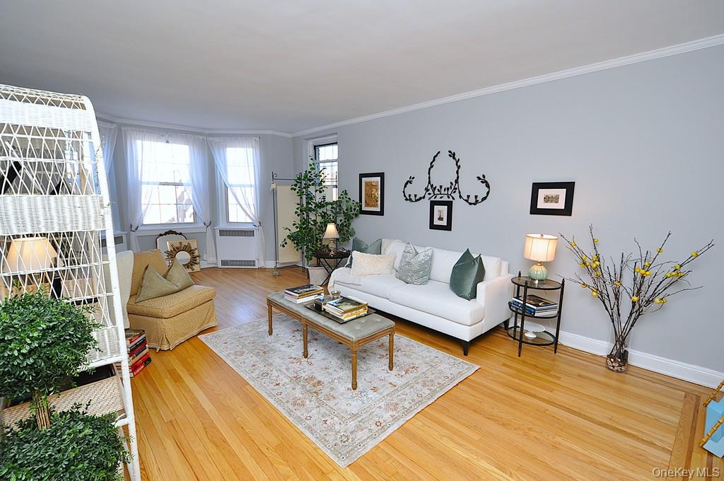 253 Garth Road, Unit 6J Scarsdale, NY 10583 - Photo 4 of 41 Oversized living room has a bay window, stunning hardwood floors and opens to the dining room. The living room is approx 22'-3" x 12'-8"