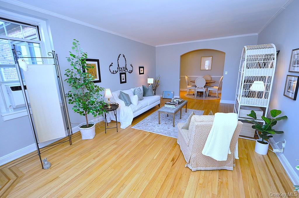 253 Garth Road, Unit 6J Scarsdale, NY 10583 - Photo 5 of 41 Oversized living room has a bay window, stunning hardwood floors and opens to the dining room. The living room is approx 22'-3" x 12'-8"