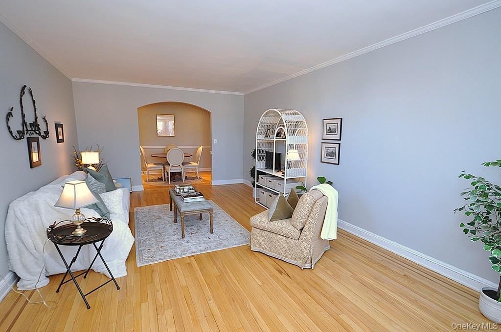 253 Garth Road, Unit 6J Scarsdale, NY 10583 - Photo 7 of 41 Oversized living room has a bay window, stunning hardwood floors and opens to the dining room. The living room is approx 22'-3" x 12'-8"