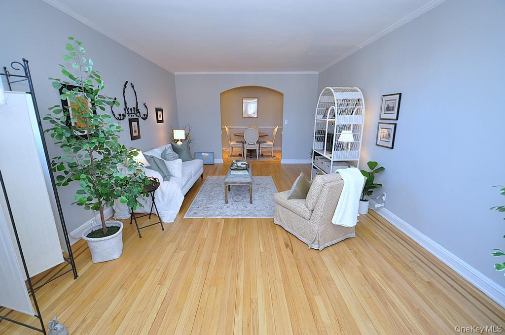253 Garth Road, Unit 6J Scarsdale, NY 10583 - Photo 8 of 41 Oversized living room has a bay window, stunning hardwood floors and opens to the dining room. The living room is approx 22'-3" x 12'-8"