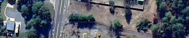 a view of a house with a plants and wooden wall