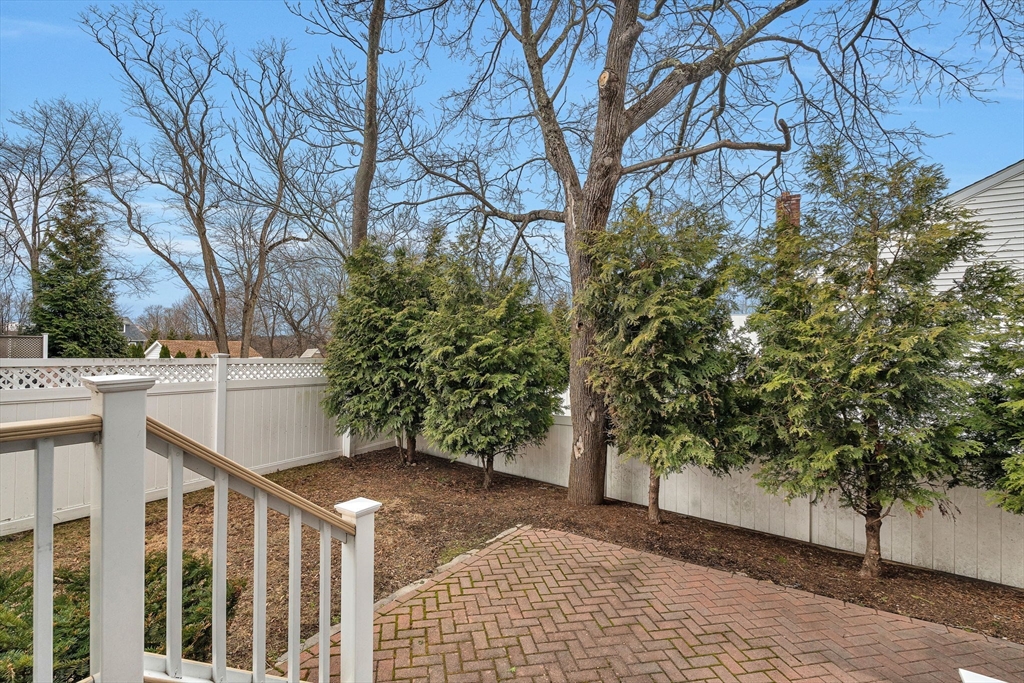 385 Hillside Avenue, Unit 385 Needham, MA 02494 - Photo 35 of 37 a view of a white house with a yard