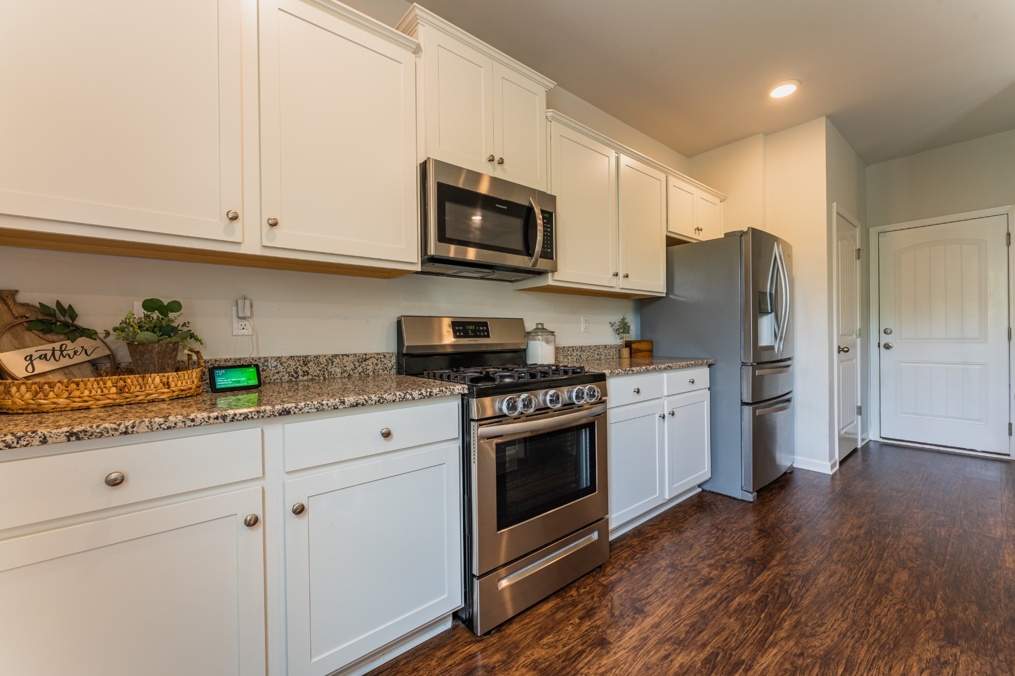 752 Prominence Road Columbia, TN 38401 - Photo 15 of 35 a kitchen with stainless steel appliances white cabinets and a stove a refrigerator with wooden floor
