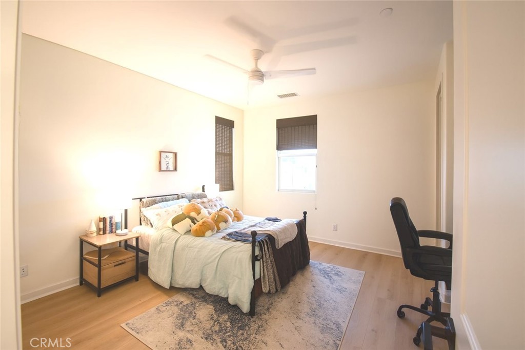 279 Barnes Road Tustin, CA 92782 - Photo 11 of 31 a spacious bedroom with a bed and a chair