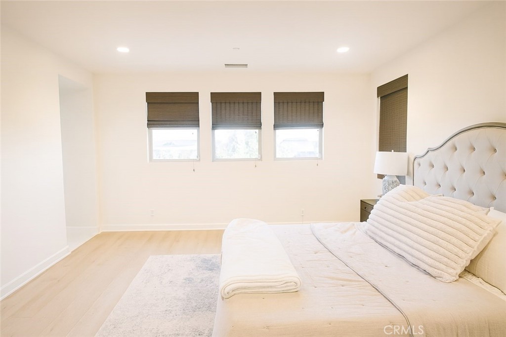 279 Barnes Road Tustin, CA 92782 - Photo 13 of 31 a bedroom with a large bed and a painting on the wall