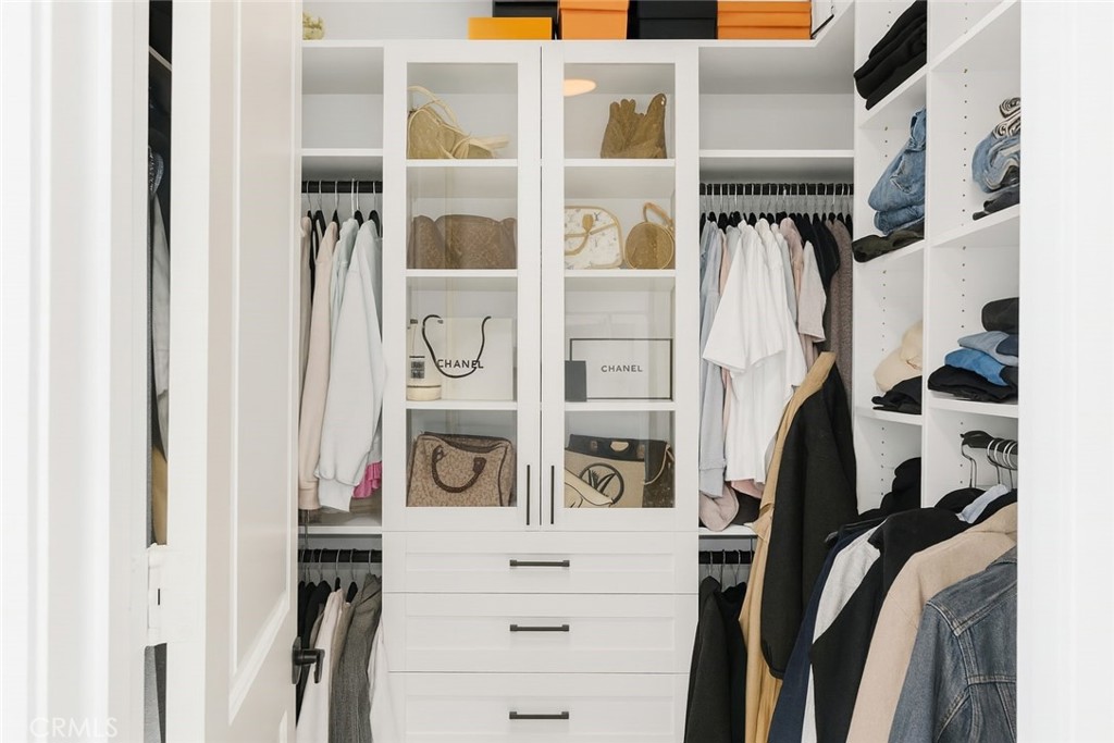 279 Barnes Road Tustin, CA 92782 - Photo 14 of 31 a view of walk in closet with clothes and shoes