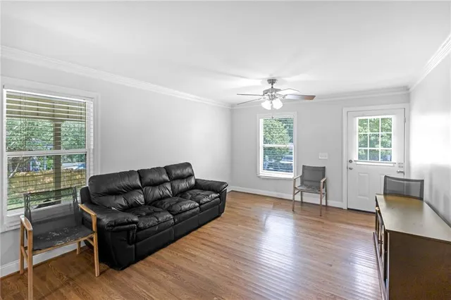a living room with furniture and a large window
